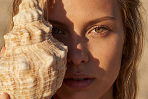 Portrait of Woman Holding a Shell, a Person Photo by Virgo Studio