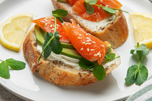Salmon avocado toasts with cream cheese and microgreens, a Photo by Olena Rudo