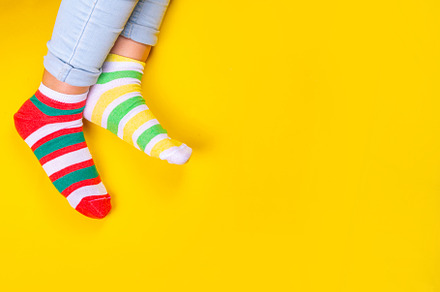 Child legs in mismatched socks, an Abstract Photo by Rimma