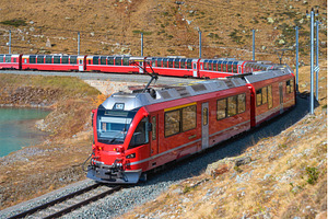 Red modern train is moving in swiss, a Transportation Photo by den-belitsky