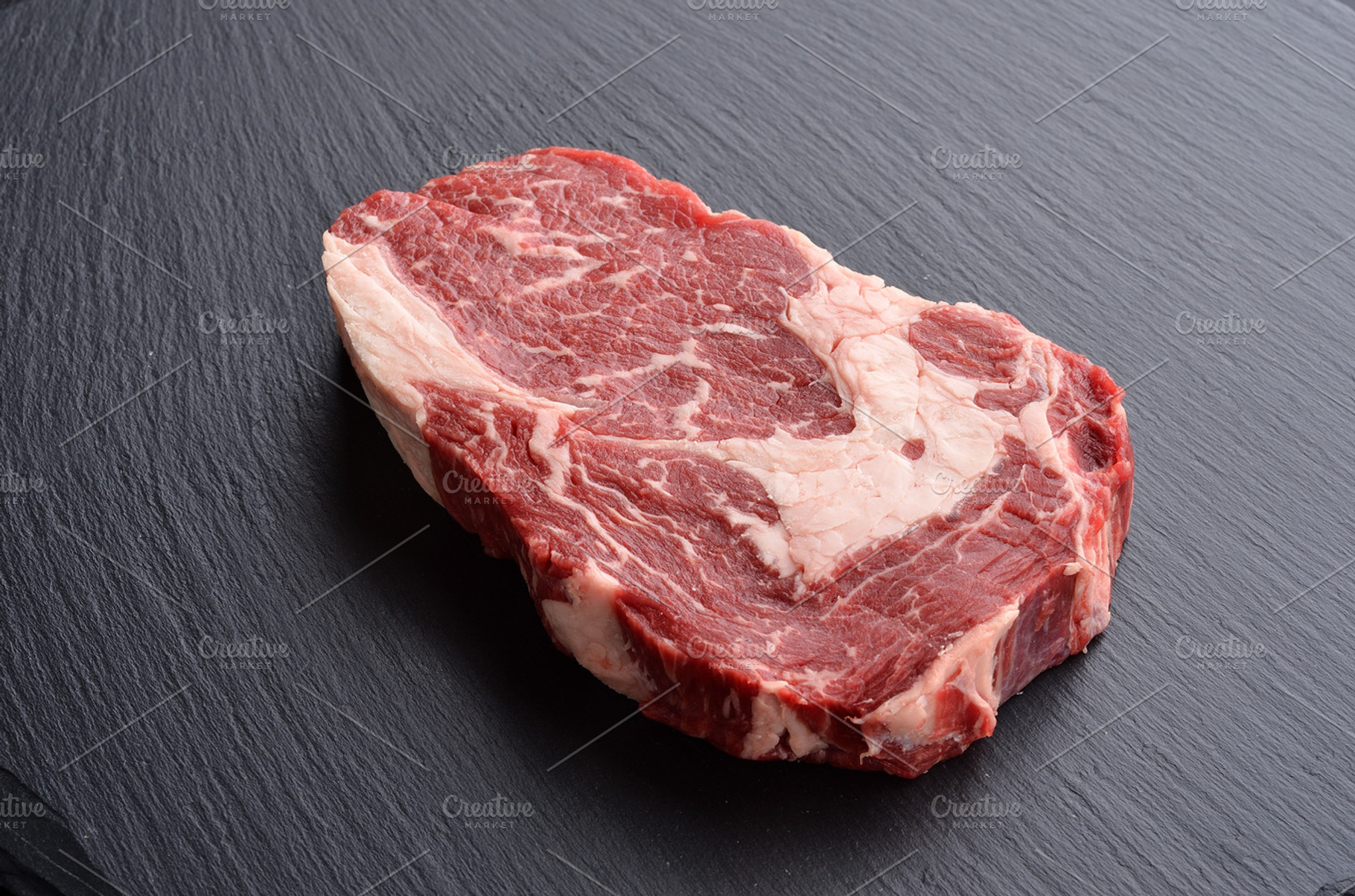 Fresh raw rib eye beef steak featuring beef, prime, and black angus, a Food & Drink Photo by Food Stock