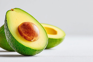 Ripe avocado halves showcasing smooth flesh and rich texture on a neutral backg, a Food & Drink Photo by AlyaAnd