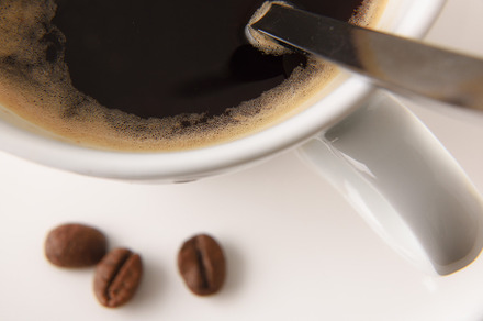 Cup with coffee on white table with beans top, a Food & Drink Photo by Davizro's Market