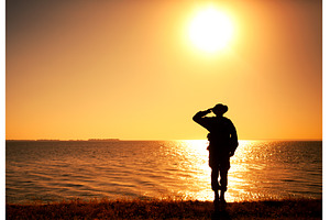 Silhouette of saluting on shore