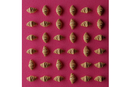 Fresh baked croissants pattern rows