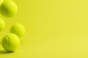 Tennis balls on chartreuse background creating dynamic sporty vi, a Photo by Dvoevnore photos
