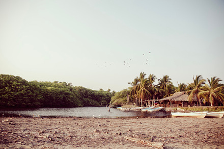 Golden lagune with cabañas and boats