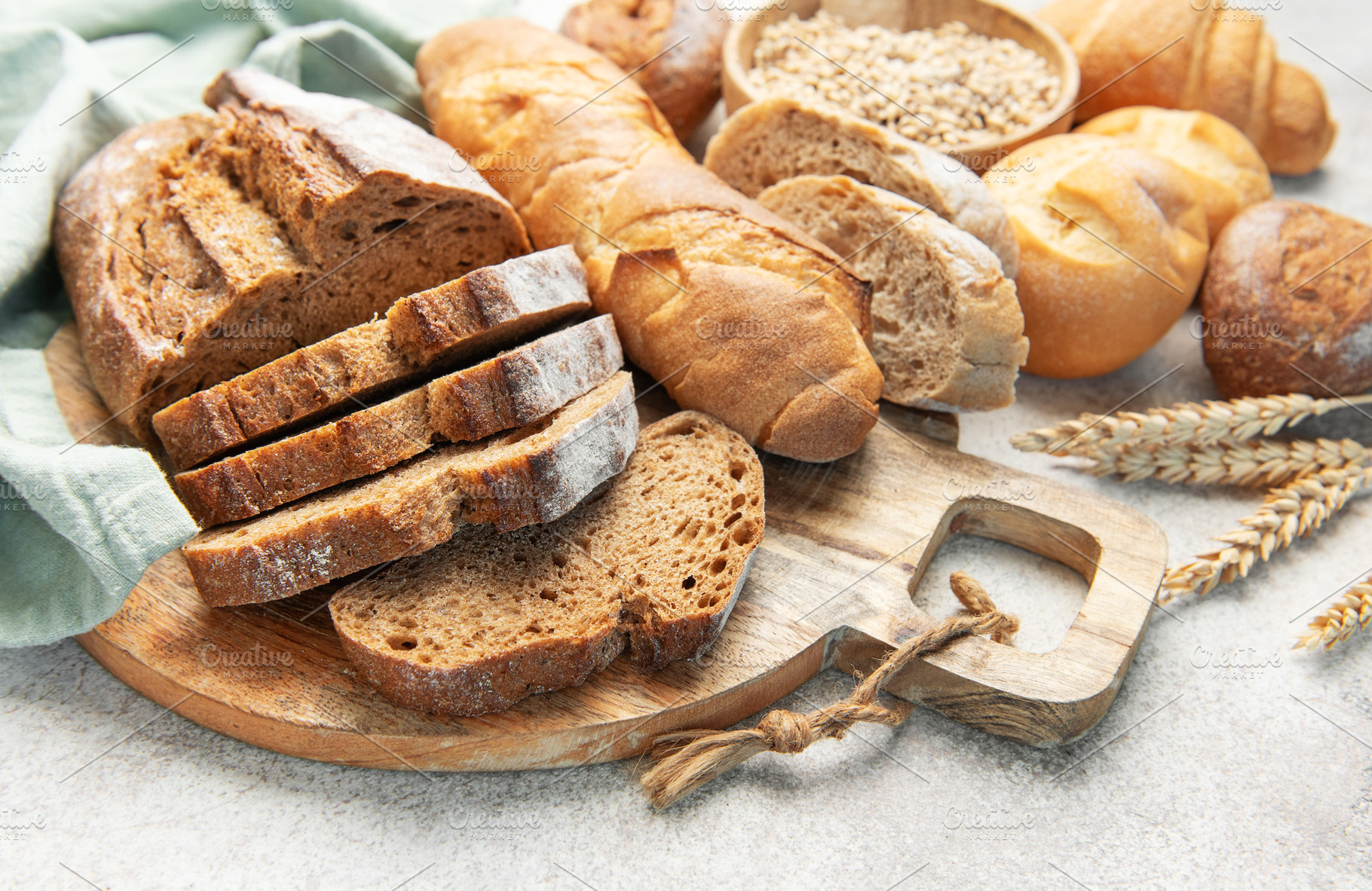 Assortment of fresh baked bread products and grains, a Food & Drink Photo by Olena Rudo