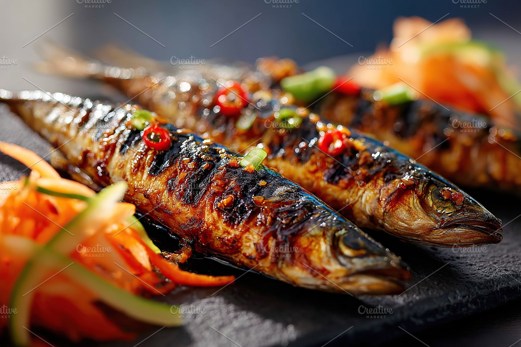 Grilled fish served with colorful vegetables on a sleek black plate at a dining, a Food & Drink Photo by AlyaAnd
