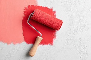 Red paint roller on white textured wall, an Arts & Entertainment Photo by AlyaAnd