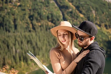 Young tourist couple, man and woman, on hiking path in mountains, a Person Photo by Olena Rudo