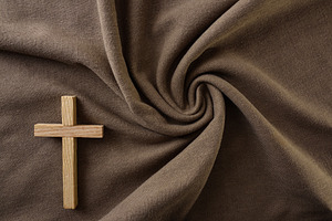 Wooden Cross on Swirled Brown Fabric Background, a Holiday Photo by Davizro's Market