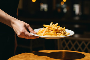 Plate of golden French fries being s, a Food & Drink Photo by professorinc