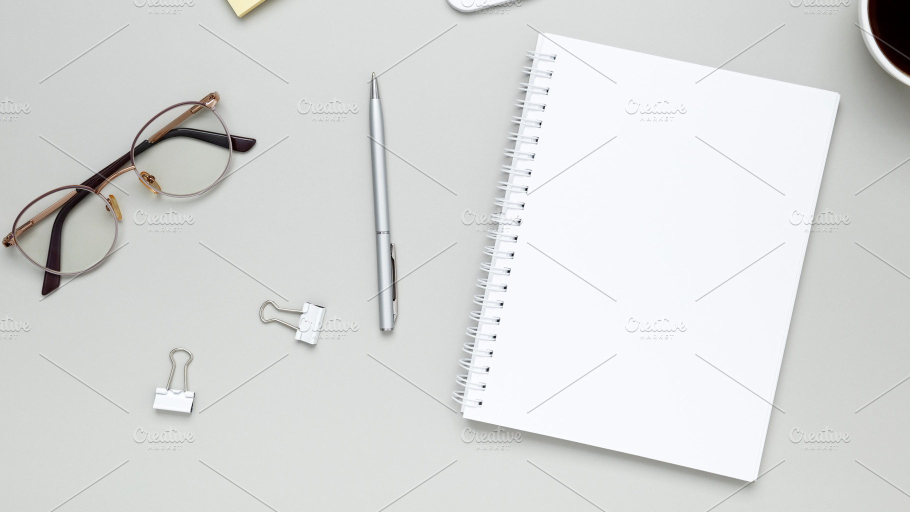 Calm and focused workspace featuring coffee cup, glasses, and notebook in minim, a Photo by matucha