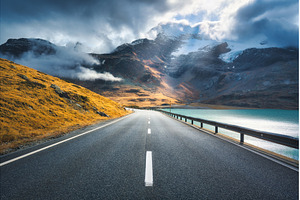 Empty road near lake in swiss snowy, a Transportation Photo by den-belitsky