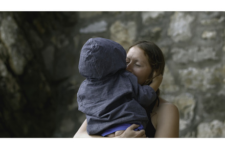 Woman hugs child on vacation, a Person Photo by Media Whale Stock