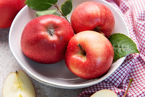 Fresh red apples in white bowl on table, a Food & Drink Photo by Olena Rudo