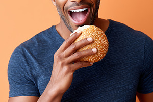 Happy black man in a blue shirt is, a Food & Drink Photo by MistyDay