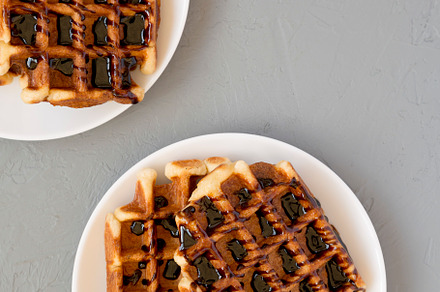 Yummy Homemade Belgian Sugar Waffles on a white plate on a gray, a Food & Drink Photo by LiudmylaChuhunova