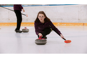 A young woman in glasses pushes off