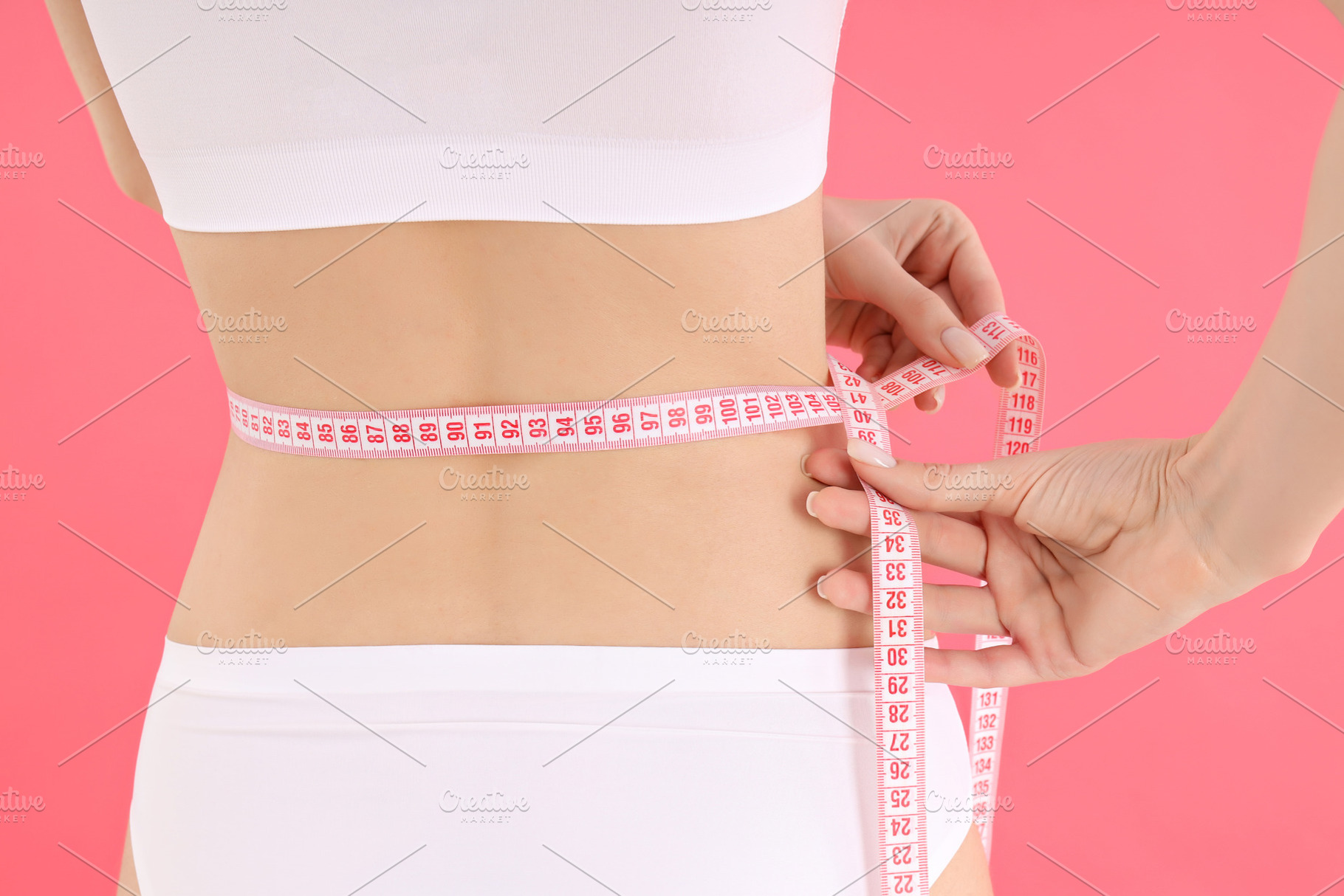 Concept of weight loss with slim young woman on pink background, a Person Photo by AtlasStudio PRO