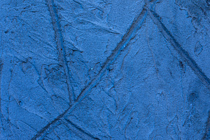 Close-up of a blue textured plaster wall with subtle cracks and, a Background Photo by Ales Munt