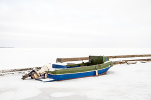 Lonely motorboat in a frozen harbour, a Transportation Photo by BOOCYS