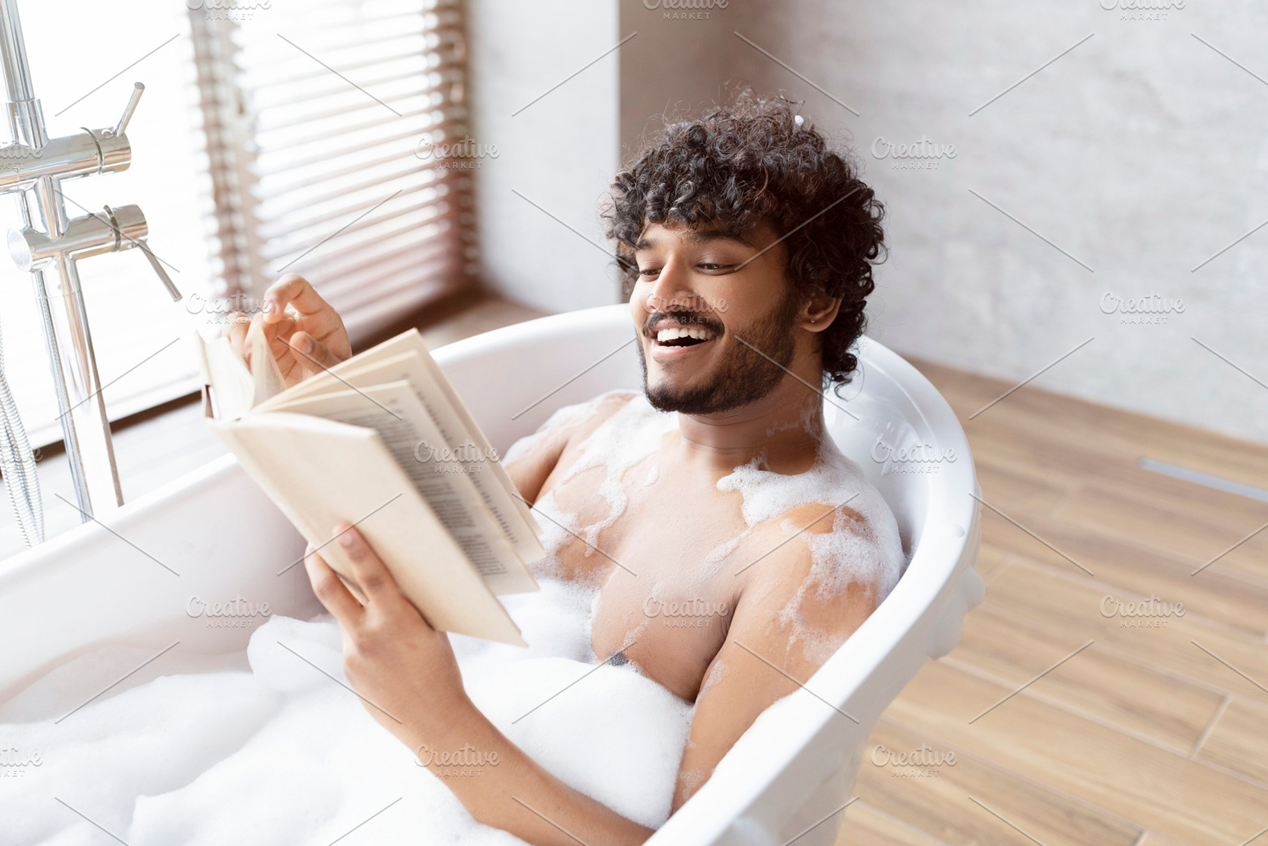 Spa procedure, self care and resting in bathroom. Happy young indian man in bat, a Person Photo by Prostock-Studio