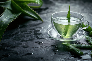 Fresh green tea in a transparent cup, a Photo by Pavel_design