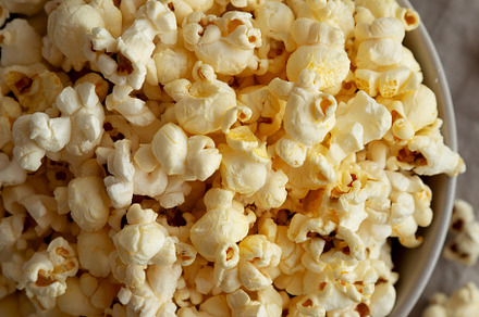 Homemade Salty Popcorn in a Bowl, top view., a Food & Drink Photo by LiudmylaChuhunova