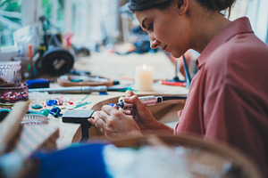 Jewelry maker works in studio