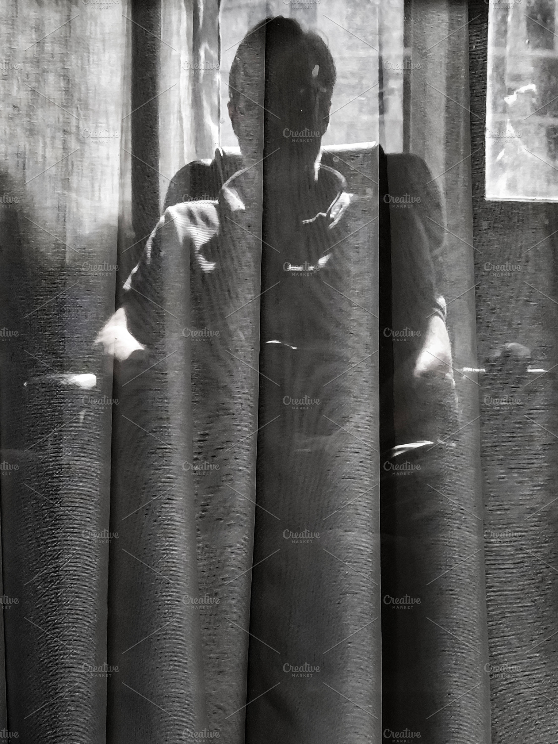 Man behind curtain in dramatic backlight, a Person Photo by DanFLCreativo