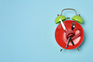 Diet concept image, red plate with crossed cutlery wrapped with, a Food & Drink Photo by ndanko