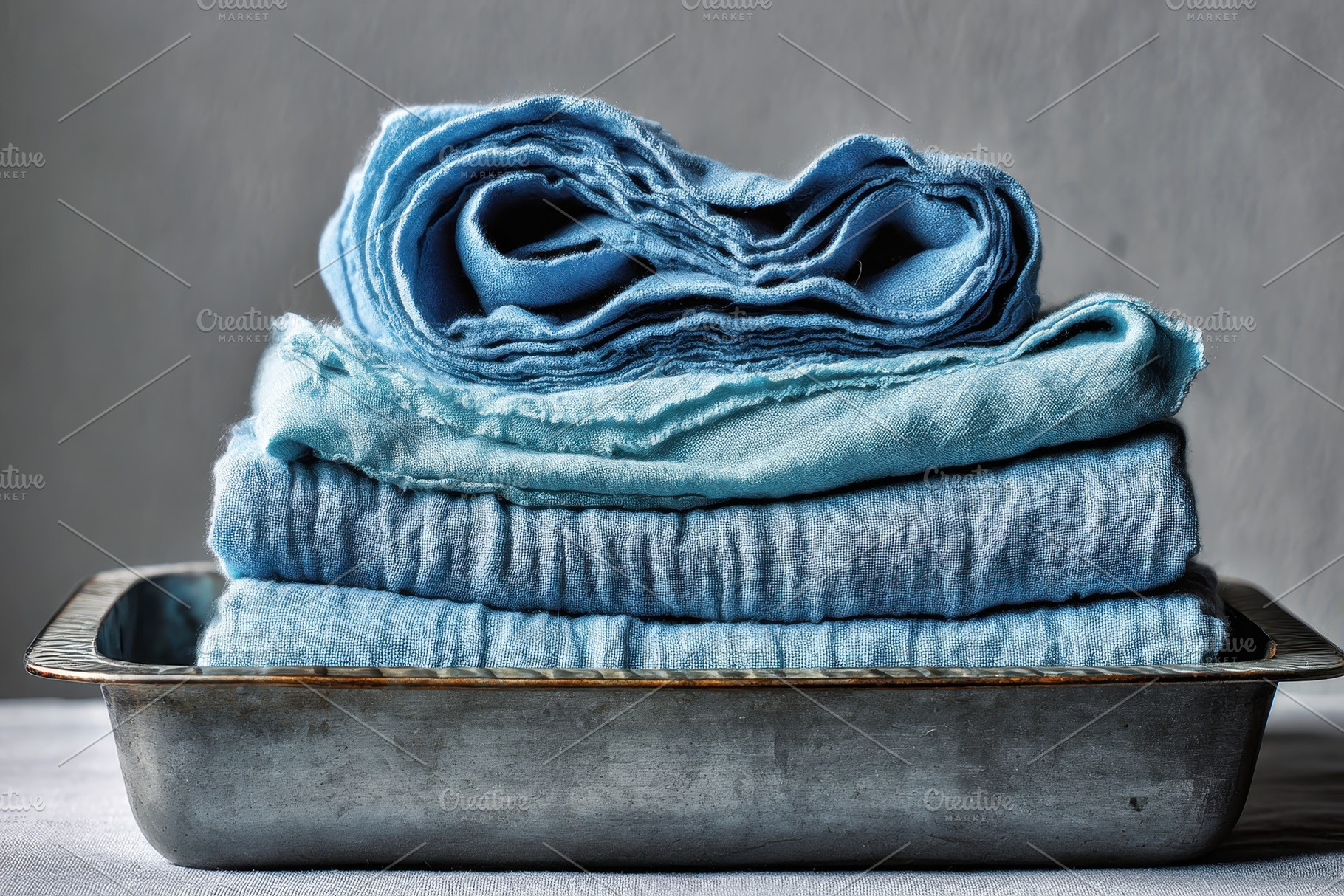Stack of blue cloth rolled & folded, a Photo by Pavel_design