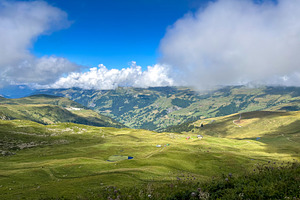 Mountain pastures and clouds above alpine valleys in Les Contami, a Nature Photo by GoodGoods