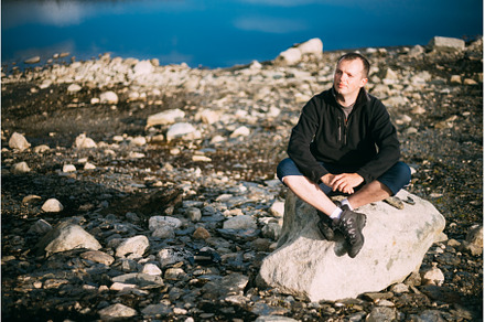 Man Sitting On Stone In Norwegian, a Sports & Recreation Photo by Our Amazing World