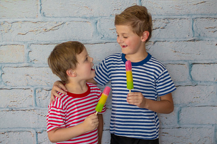 smiling boys are eating ice cream, a Person Photo by Anno Urbis