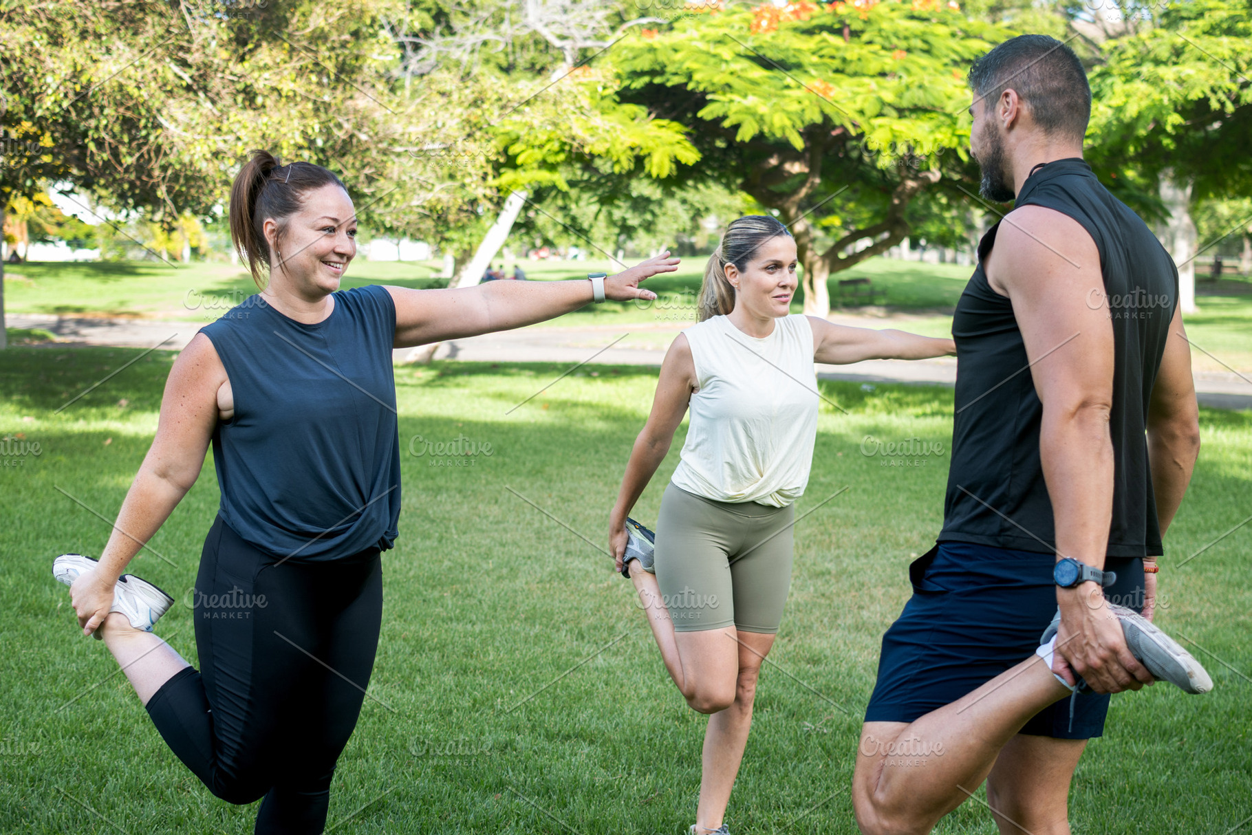 Fitness friends stretching together before an outdoor workout in a park, a Sports & Recreation Photo by etorres69