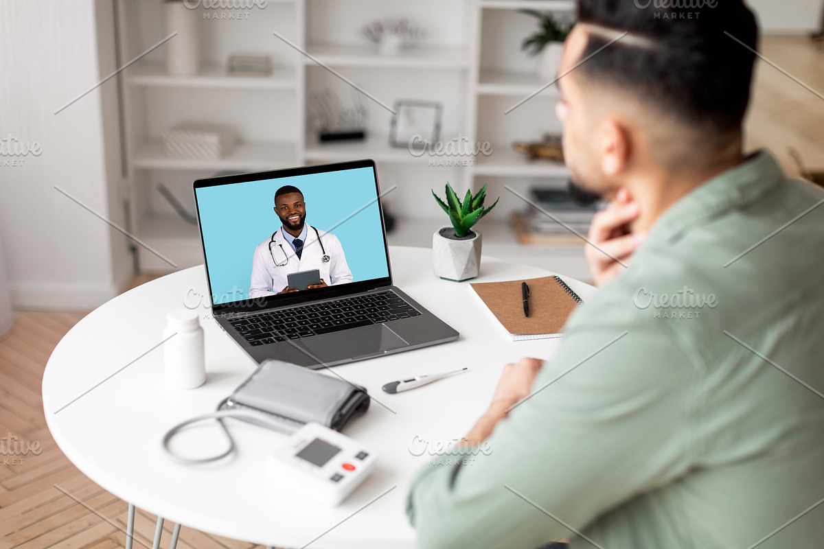 Millennial arab man checks throat, calls online to doctor on laptop screen in l, a Photo by Prostock-Studio (Photo 2 of 2)
