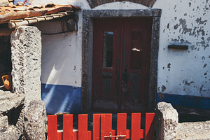 Red gate at rustic stone house, an Architecture Photo by SkyNext