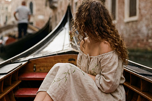 Romantic Boat through Venetian Canal, a Person Photo by Virgo Studio