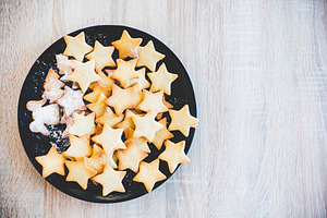 Butter cookies in black ceramic dish containing background, baked, and bakery, a Food & Drink Photo by MadPhotos