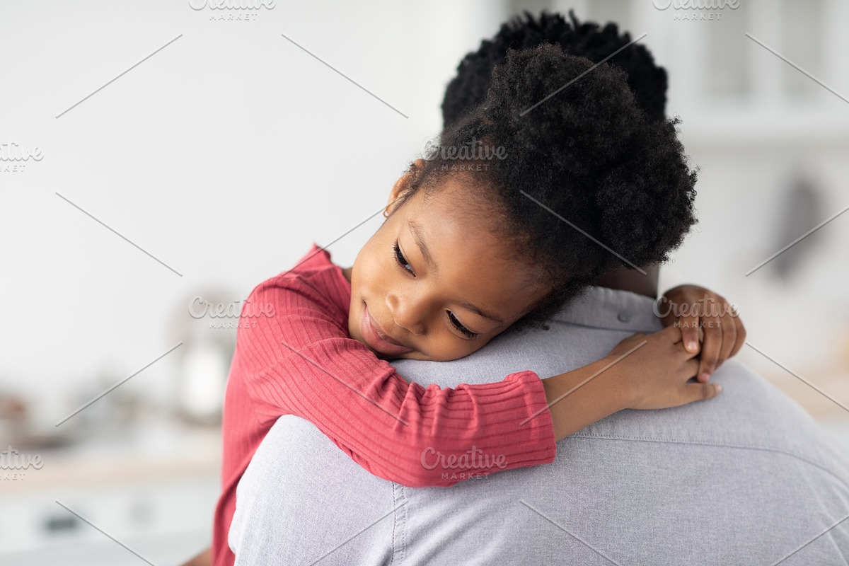 Smiling little black girl hugging her daddy, a Photo by Prostock-Studio (Photo 2 of 2)