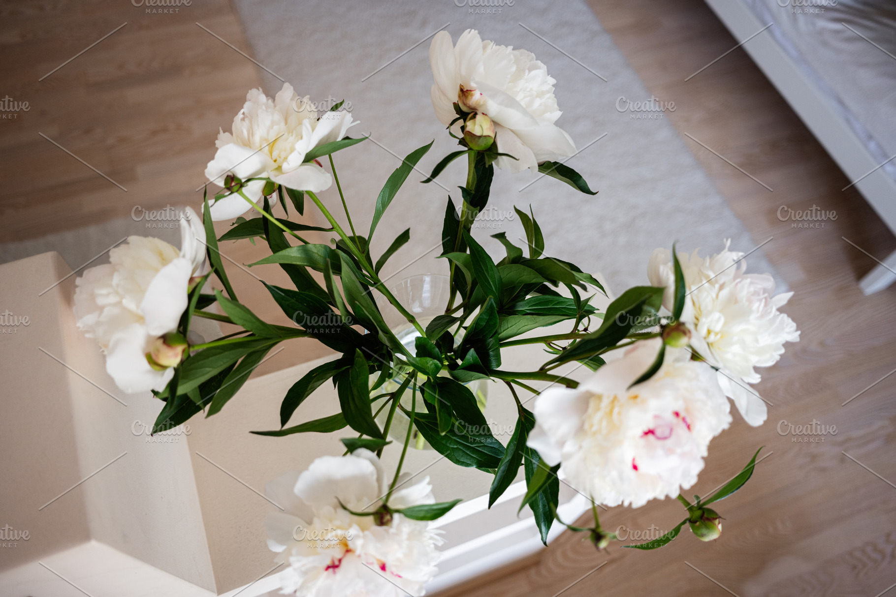 White Peony Flowers in a Glass Vase on a Bright Wooden Surface, a Photo by AS photostudio
