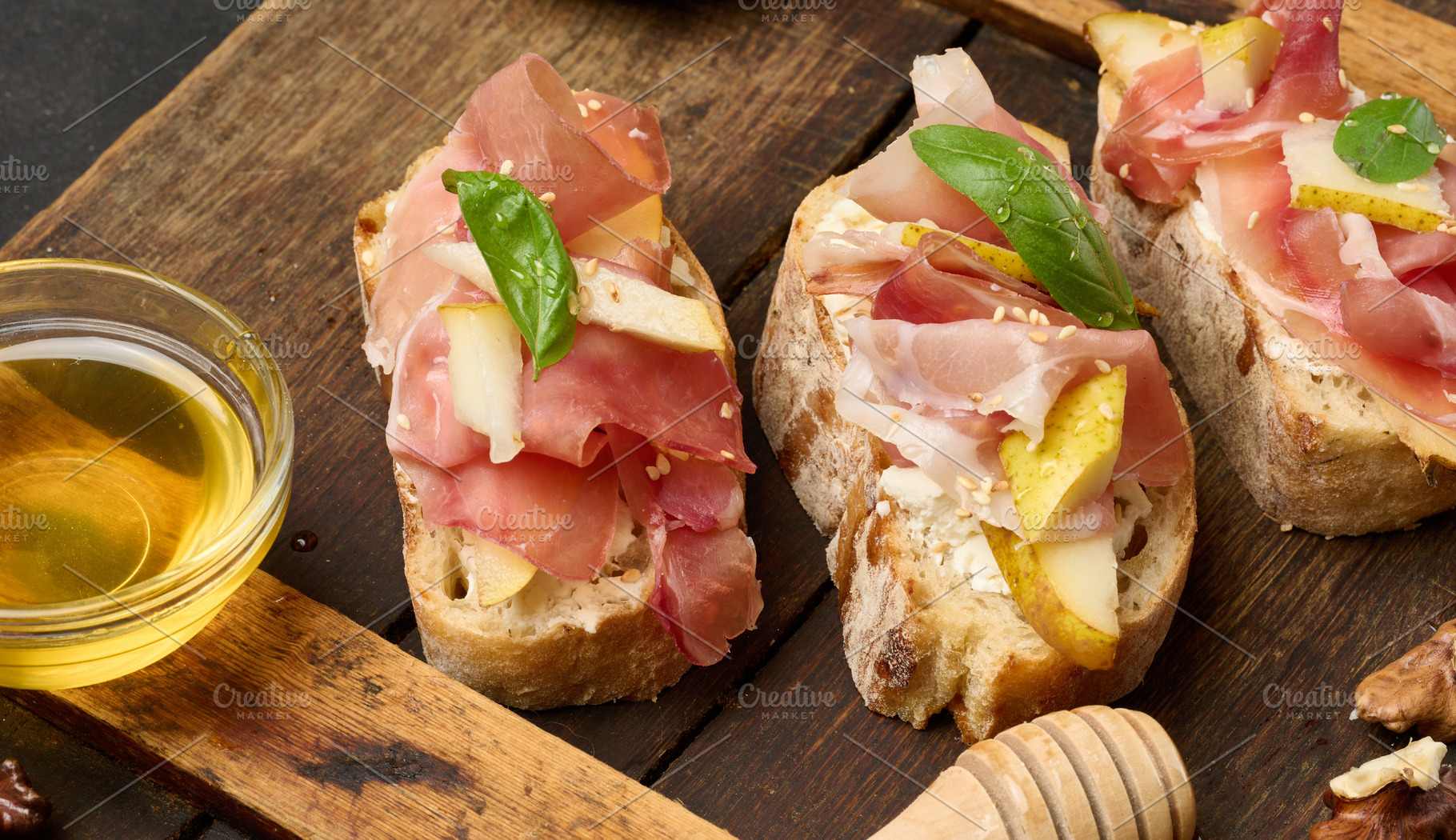 An arrangement of bruschetta with prosciutto, pear and cheese, s, a Food & Drink Photo by ndanko