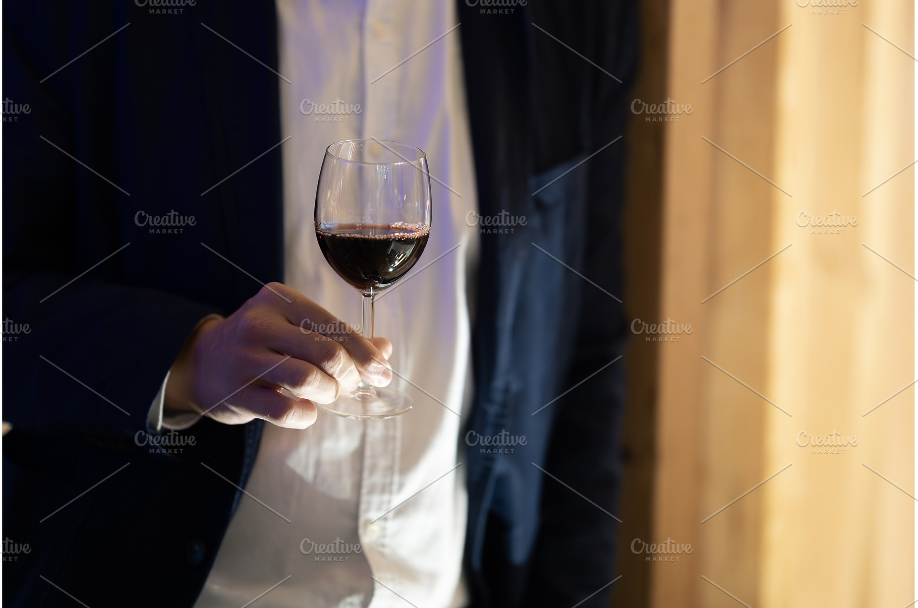 Hand holding a wine glass, a Person Photo by Barcelona_dreams