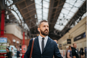Businessman with a bag waiting for, a Person Photo by HalfPoint