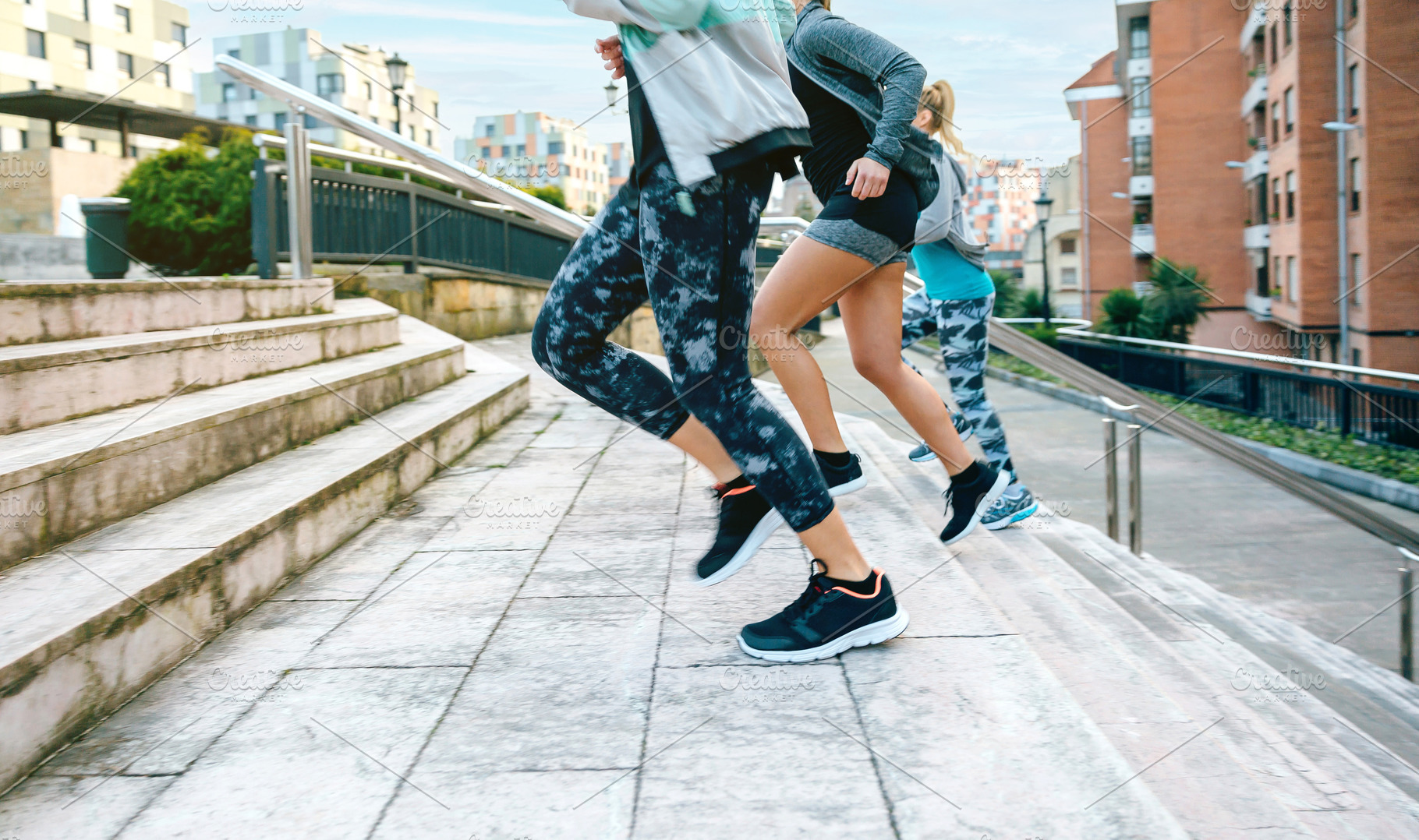 Young women friends training running up stairs in town, a Sports & Recreation Photo by davidpereiras