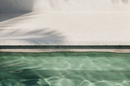 Tropical summer background with swimming pool water.