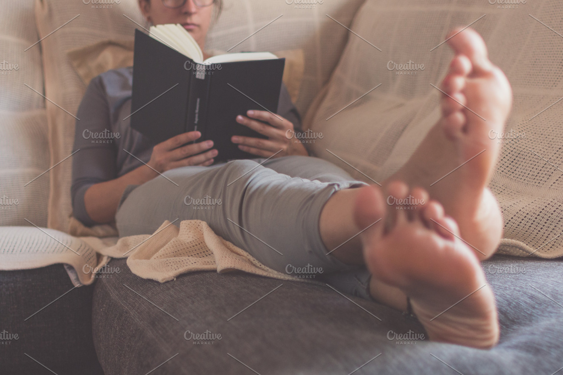 Couch and book, a Person Photo by Tan Tranquila